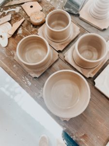 white plastic cups on white wooden table